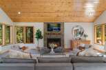Experience cozy living in this inviting living room, featuring a stunning stone fireplace as the centerpiece.