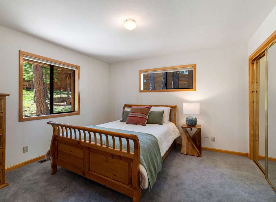 This cozy bedroom features a charming wooden sleigh bed, perfect for restful nights.