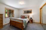This cozy bedroom features a charming wooden sleigh bed, perfect for restful nights.