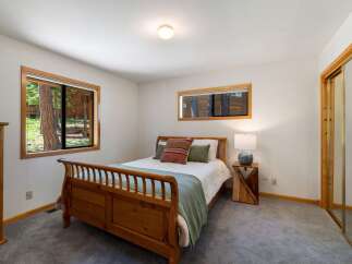 This cozy bedroom features a charming wooden sleigh bed, perfect for restful nights.