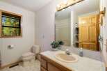 This charming bathroom features a comfortable toilet and a spacious vanity with a sink, perfect for everyday routines.