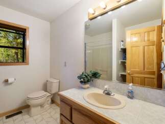 This charming bathroom features a comfortable toilet and a spacious vanity with a sink, perfect for everyday routines.