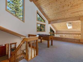 Experience the charm of this mountain retreat, featuring a spacious loft area perfect for recreation and relaxation.
