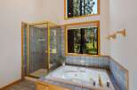Experience ultimate relaxation in this luxurious bathroom featuring a spacious jetted tub and a separate glass-enclosed shower.