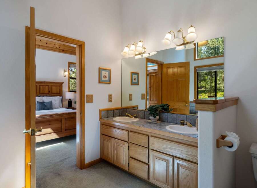 This charming bathroom features a double vanity with ample counter space and storage, perfect for any household.