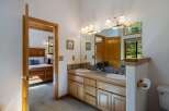 This charming bathroom features a double vanity with ample counter space and storage, perfect for any household.