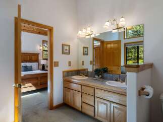 This charming bathroom features a double vanity with ample counter space and storage, perfect for any household.