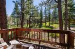 Enjoy the serene mountain lifestyle from this charming cabin deck, offering breathtaking views of the surrounding pine forest.