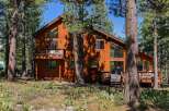 Nestled amidst tall pine trees, this stunning wooden cabin offers a serene retreat.