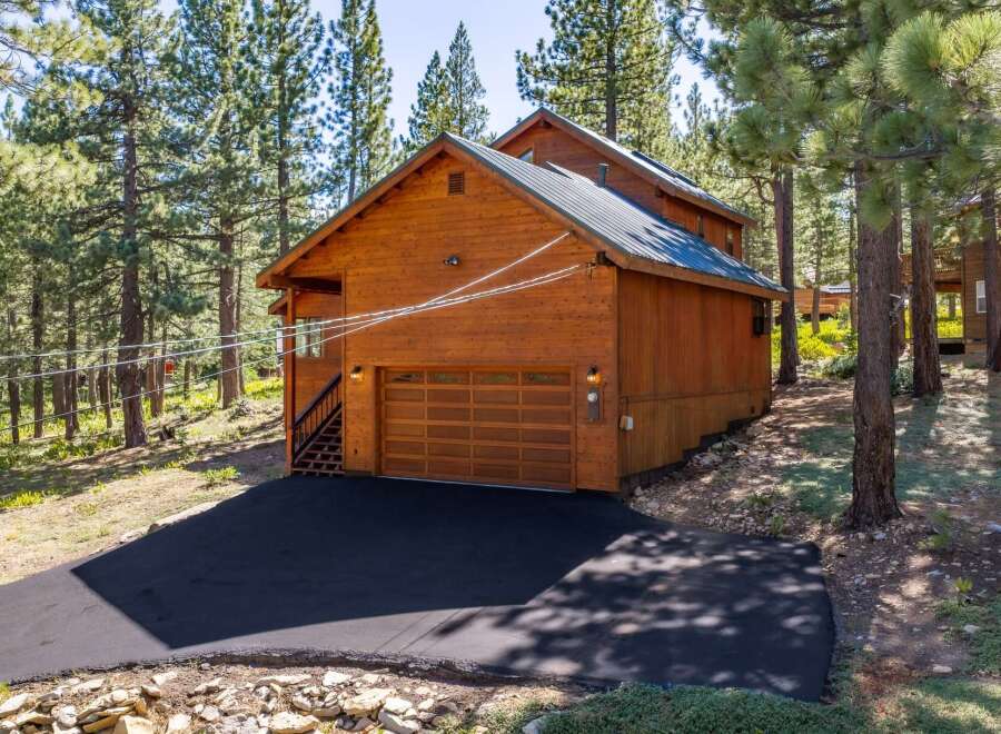 Discover this charming wooden cabin nestled amongst tall pine trees, offering a serene mountain retreat.