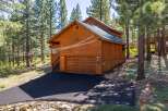 Discover this charming wooden cabin nestled amongst tall pine trees, offering a serene mountain retreat.