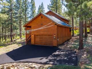 Discover this charming wooden cabin nestled amongst tall pine trees, offering a serene mountain retreat.