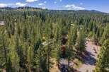 Nestled amidst a dense forest of mature pine trees, this property offers a secluded and serene mountain retreat.