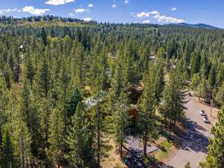 Nestled amidst a dense forest of mature pine trees, this property offers a secluded and serene mountain retreat.