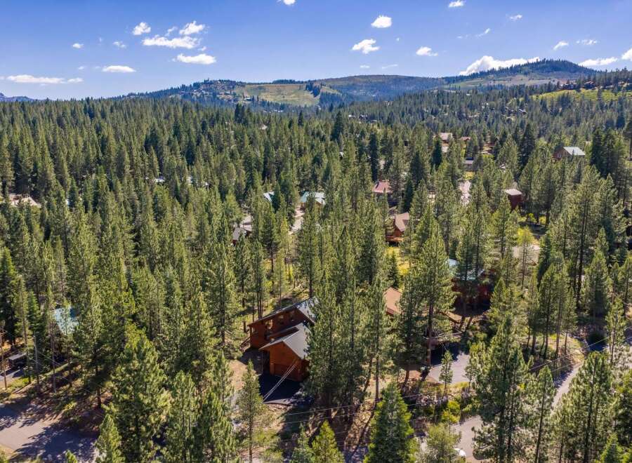 Nestled amidst a dense forest of towering pine trees, this property offers a serene and private retreat.