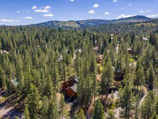 Nestled amidst a dense forest of towering pine trees, this property offers a serene and private retreat.