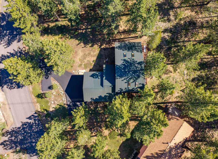 Discover this stunning property nestled among mature pine trees, offering a serene and private retreat.