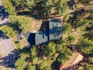 Discover this stunning property nestled among mature pine trees, offering a serene and private retreat.