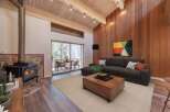 Experience cozy living in this stunning living room featuring a rustic stone fireplace with a wood-burning stove, perfect for chilly evenings.