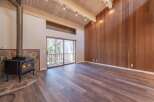 Experience cozy living in this spacious room featuring a striking stone fireplace with a wood-burning stove, perfect for chilly evenings.