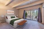Experience serene mountain living in this beautifully appointed bedroom, featuring a plush king-sized bed and a cozy seating area.