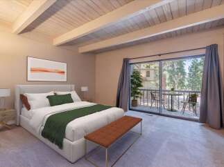 Experience serene mountain living in this beautifully appointed bedroom, featuring a plush king-sized bed and a cozy seating area.