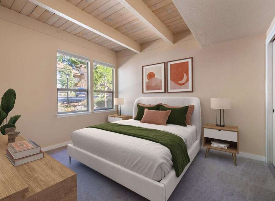 Discover this inviting bedroom featuring a plush white bed adorned with deep green and terracotta accents, complemented by two minimalist bedside tables with lamps.