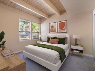 Discover this inviting bedroom featuring a plush white bed adorned with deep green and terracotta accents, complemented by two minimalist bedside tables with lamps.