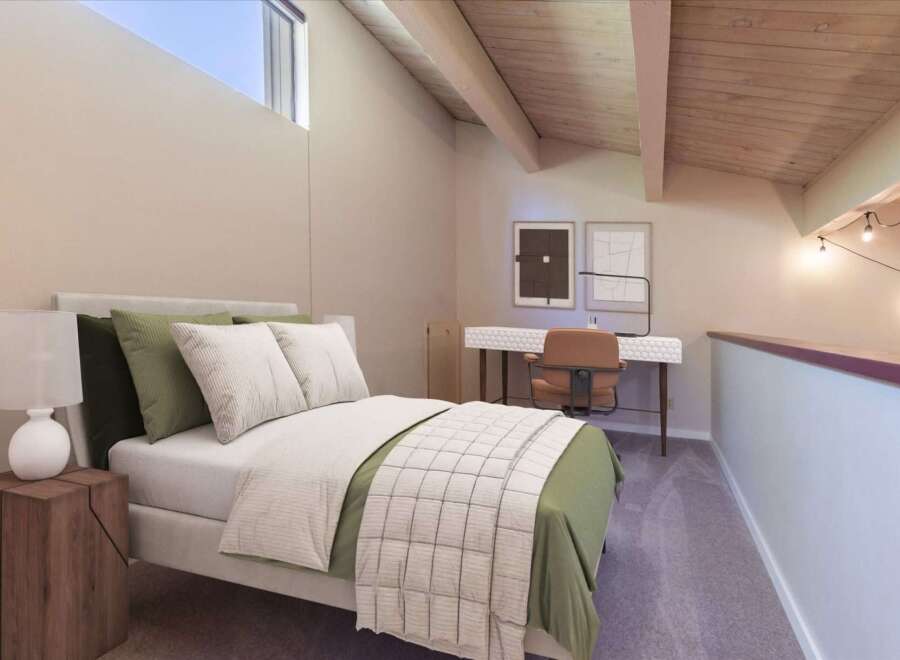 Discover this charming loft bedroom featuring a comfortable bed with plush pillows and a stylish green duvet.