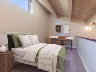 Discover this charming loft bedroom featuring a comfortable bed with plush pillows and a stylish green duvet.
