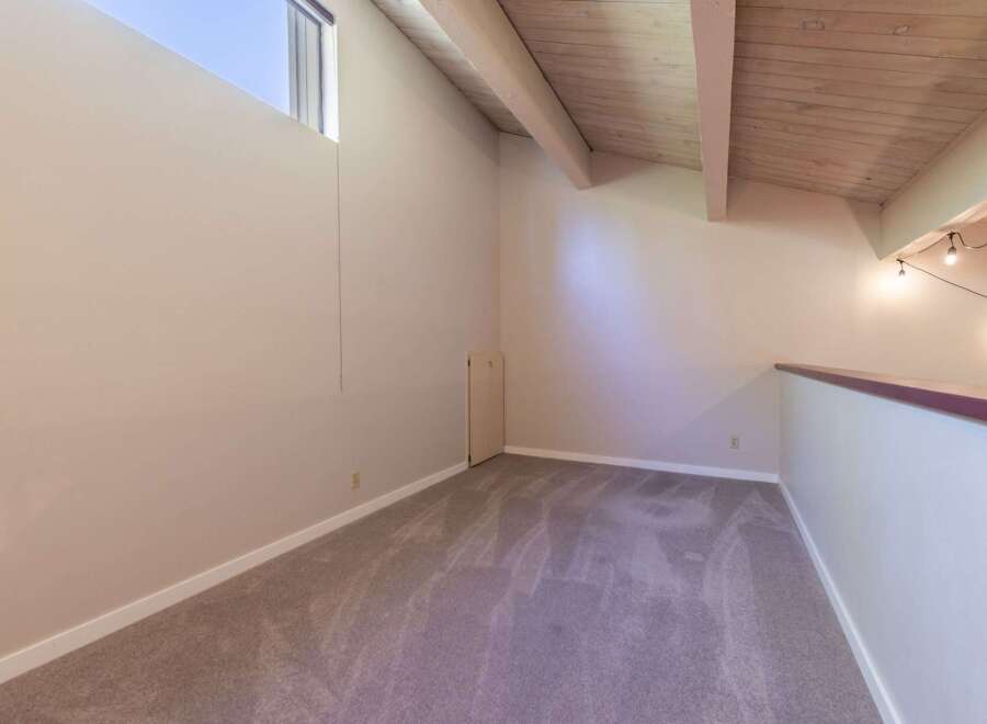 Discover this charming loft space, perfect for a home office or cozy reading nook.