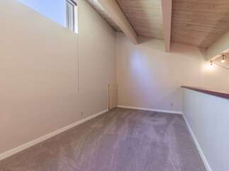 Discover this charming loft space, perfect for a home office or cozy reading nook.