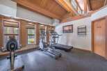 Stay active in this well-equipped home gym featuring a treadmill and elliptical machine, perfect for your daily workouts.