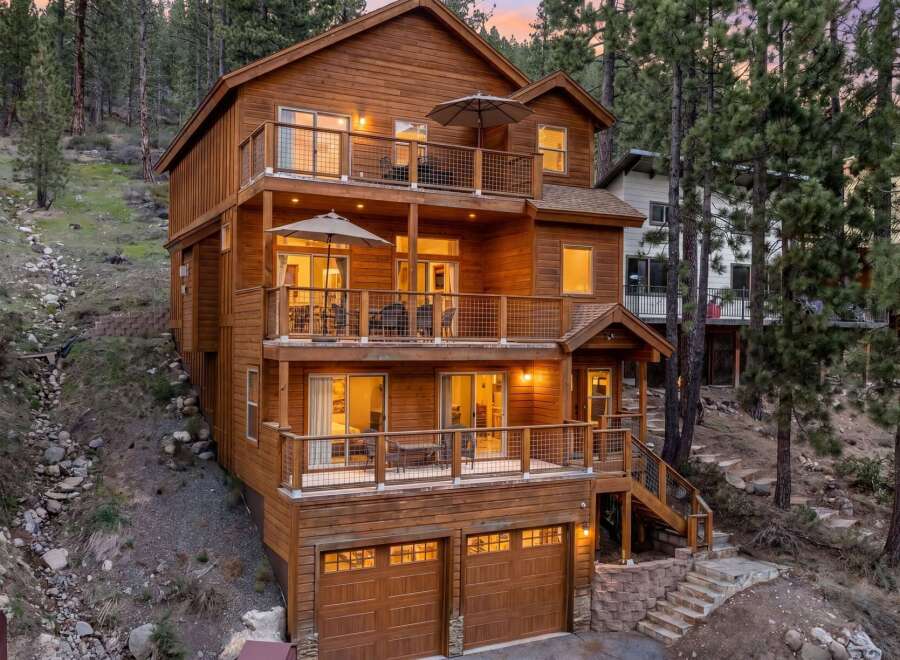Experience luxury mountain living in this stunning multi-level wooden home nestled among tall pine trees.