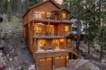 Experience luxury mountain living in this stunning multi-level wooden home nestled among tall pine trees.