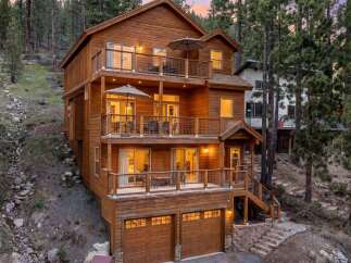 Experience luxury mountain living in this stunning multi-level wooden home nestled among tall pine trees.