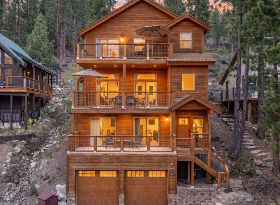 Experience mountain living in this stunning multi-level wooden home, nestled amidst towering pine trees.