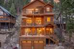 Experience mountain living in this stunning multi-level wooden home, nestled amidst towering pine trees.