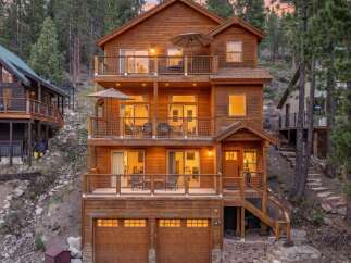 Experience mountain living in this stunning multi-level wooden home, nestled amidst towering pine trees.