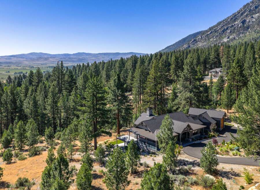 Nestled amidst a dense forest and rolling hills, this stunning mountain home offers unparalleled privacy and breathtaking views.
