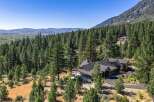 Nestled amidst a dense forest and rolling hills, this stunning mountain home offers unparalleled privacy and breathtaking views.