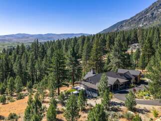 Nestled amidst a dense forest and rolling hills, this stunning mountain home offers unparalleled privacy and breathtaking views.