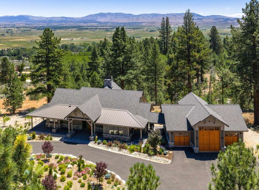 Experience luxury living in this stunning mountain retreat, nestled amidst towering pine trees with breathtaking panoramic views of the valley and distant mountains.
