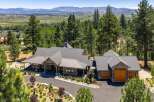 Experience luxury living in this stunning mountain retreat, nestled amidst towering pine trees with breathtaking panoramic views of the valley and distant mountains.