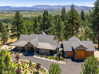 Experience luxury living in this stunning mountain retreat, nestled amidst towering pine trees with breathtaking panoramic views of the valley and distant mountains.