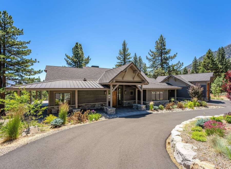 Experience luxury mountain living in this stunning custom-built home, nestled amidst towering pine trees and offering breathtaking views.