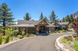 Experience luxury mountain living in this stunning custom-built home, nestled amidst towering pine trees and offering breathtaking views.