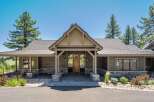 This stunning home features a modern rustic exterior with natural stone accents and dark wood siding.