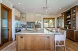 Experience luxury in this stunning kitchen featuring a large marble island with ample seating, perfect for entertaining.