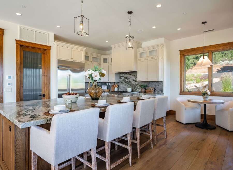Experience luxury in this stunning kitchen, featuring a large marble island with seating, perfect for entertaining.